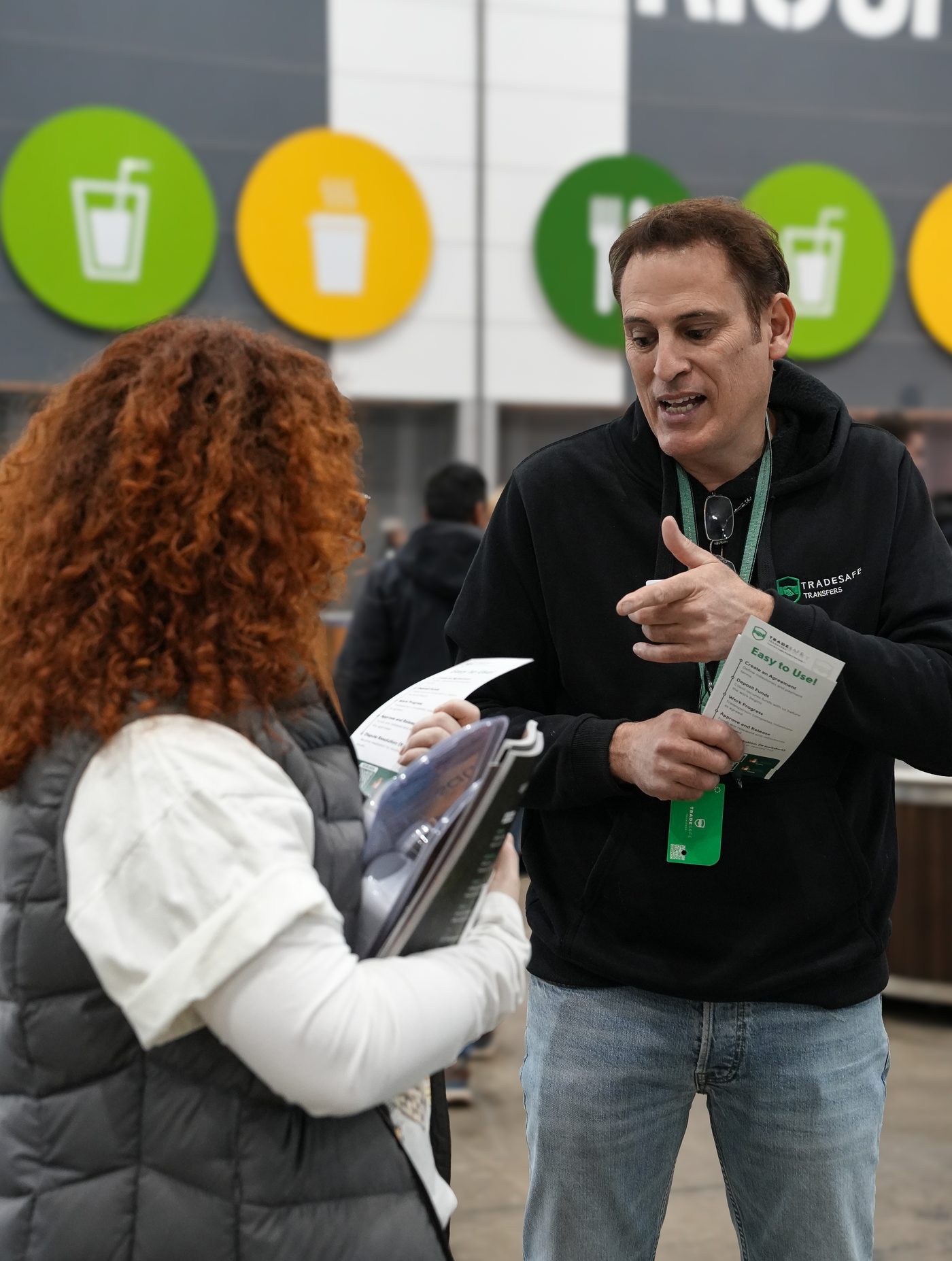 Trade Safe team member handing a flyer to a visitor